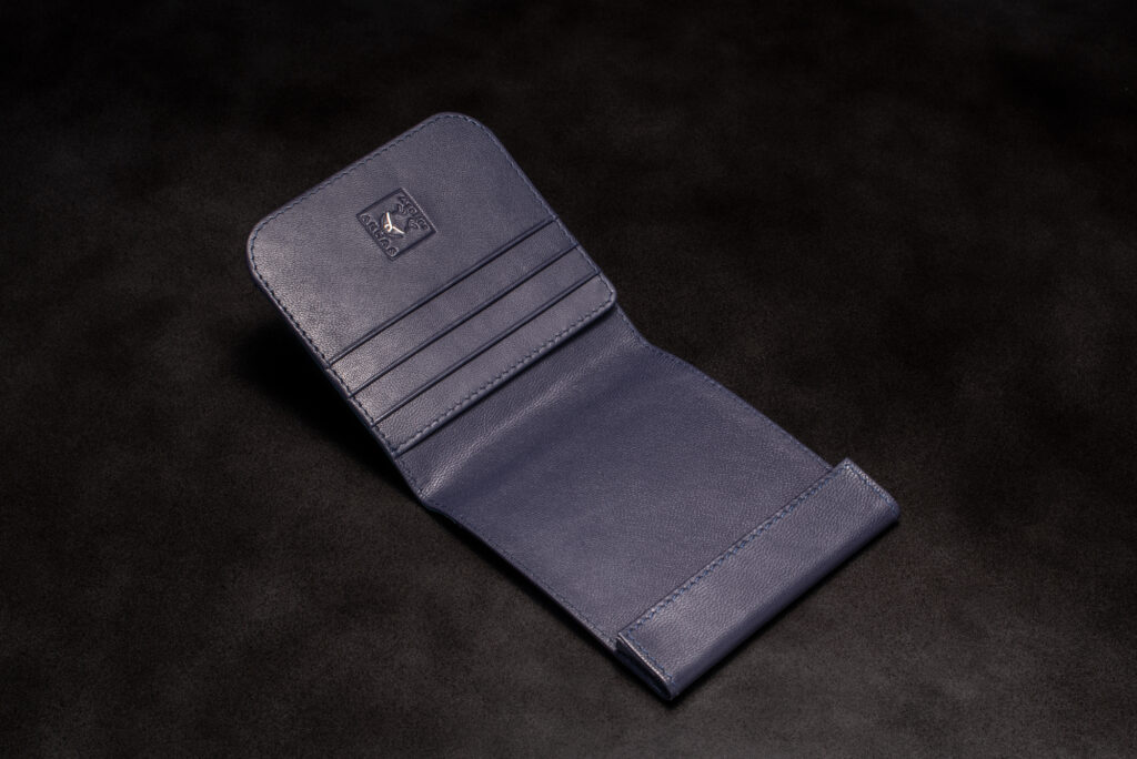 Open purple stingray leather bifold wallet by AKNAS featuring a smooth leather interior, multiple card slots and a money compartment.